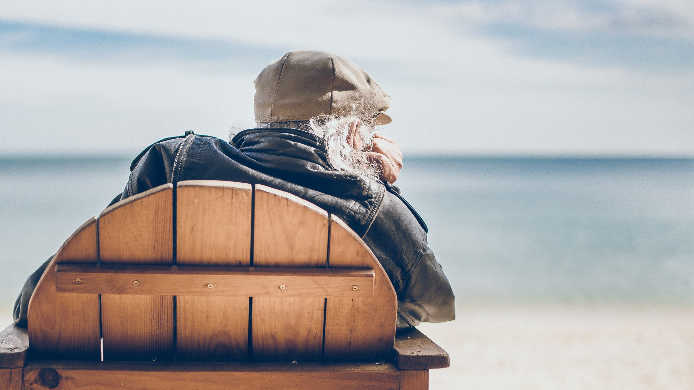 old man on a bench at the seaside
