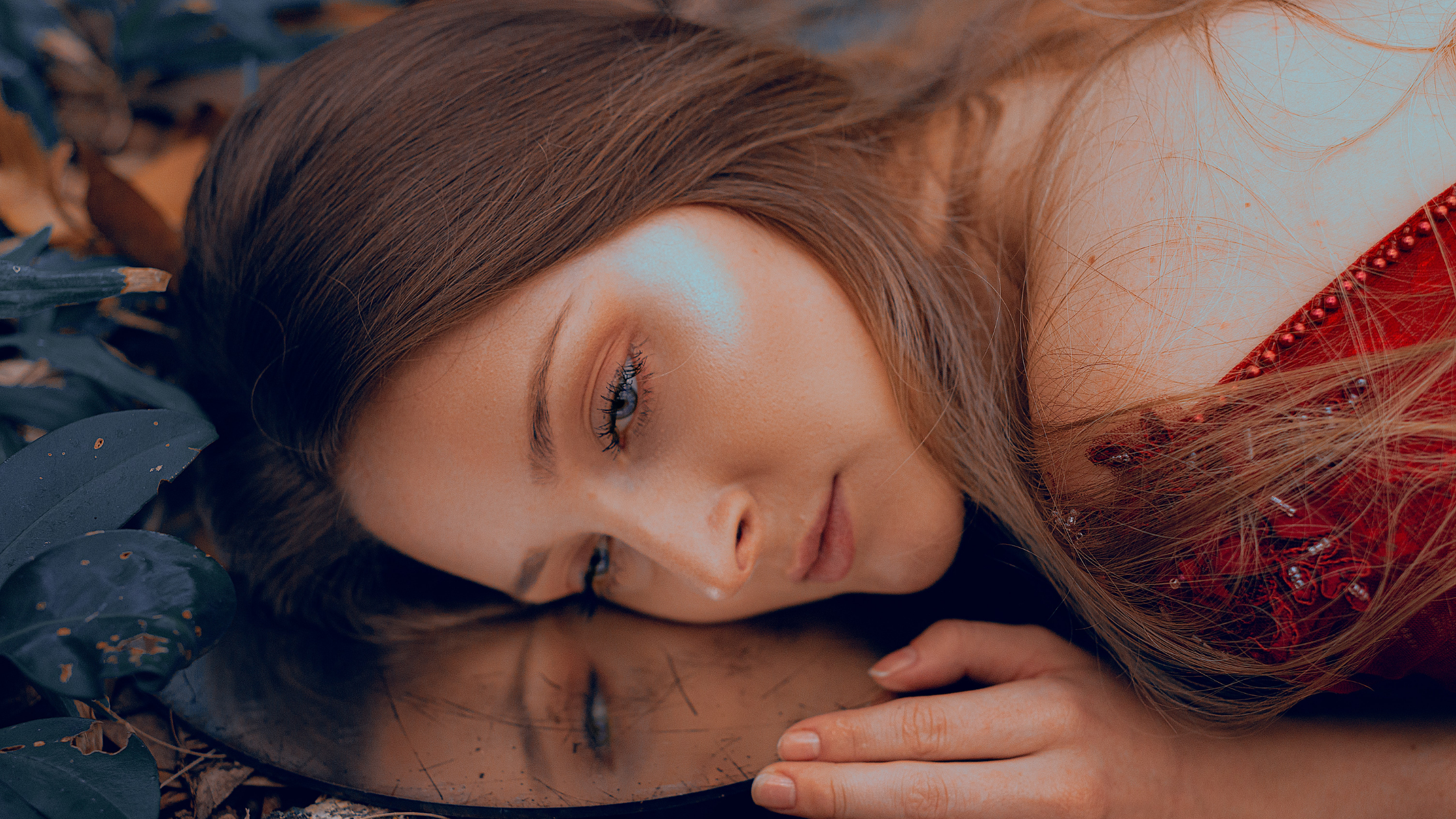 girl in red dress cast on the forest floor