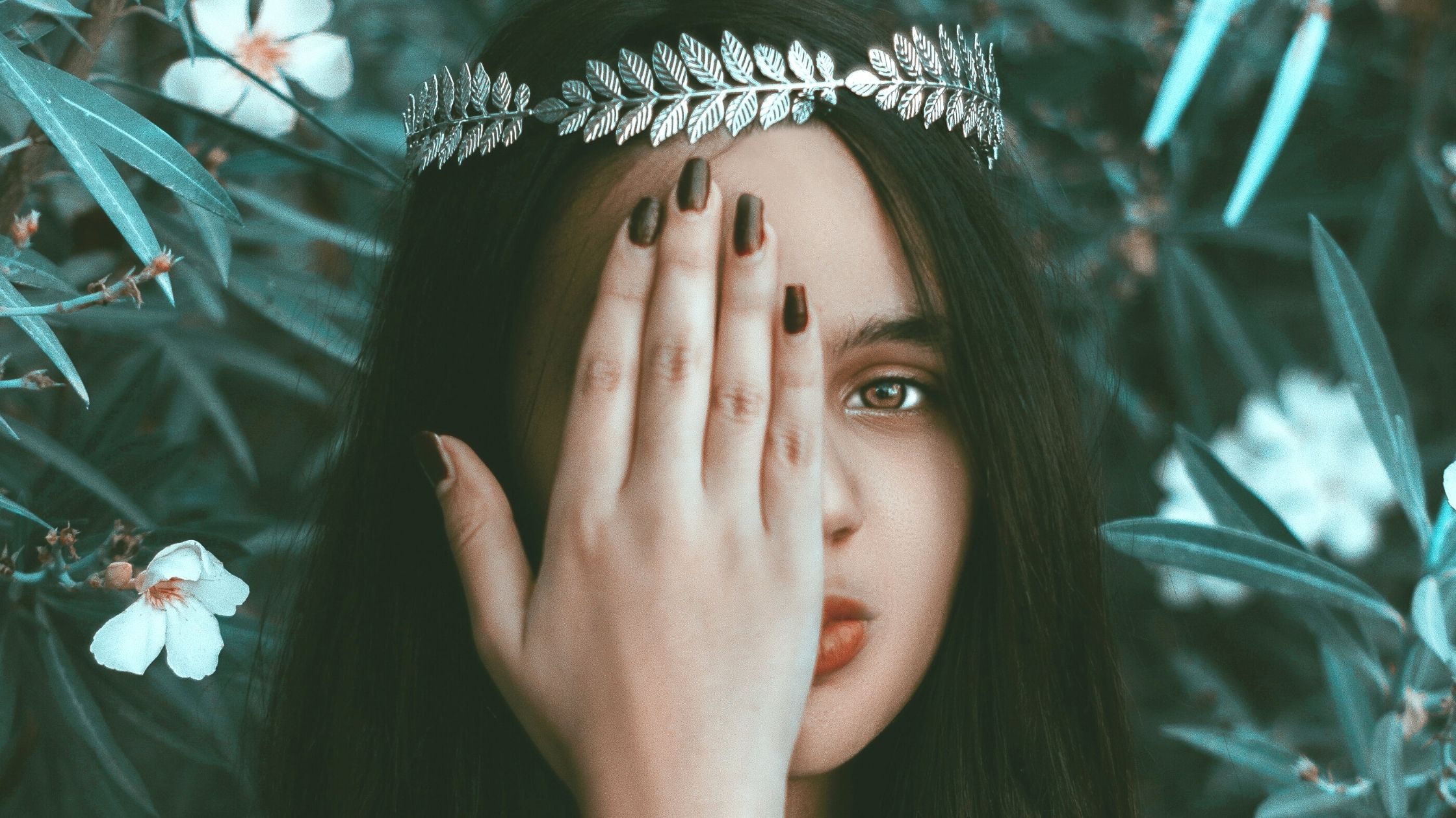 person with hand over one eye